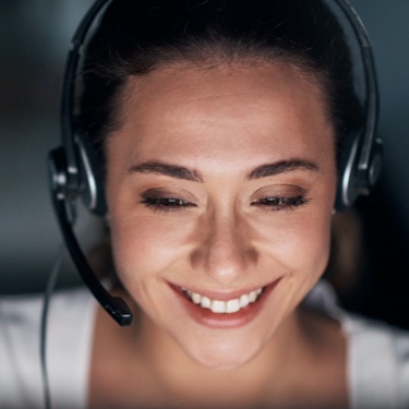 Smiling woman in white with headphones